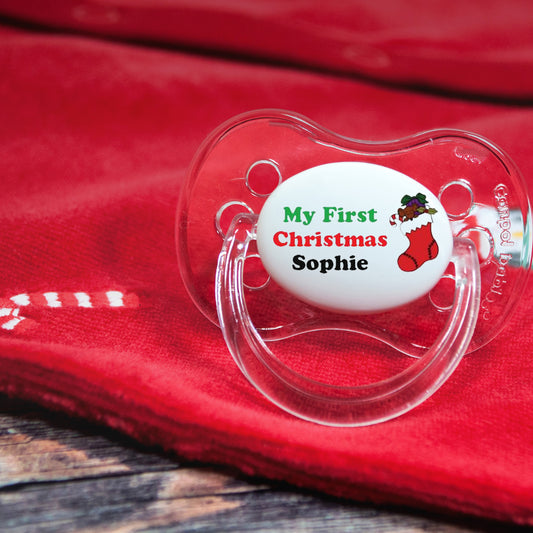 Personalised baby dummy with image of Christmas stocking and text "My first Christmas"