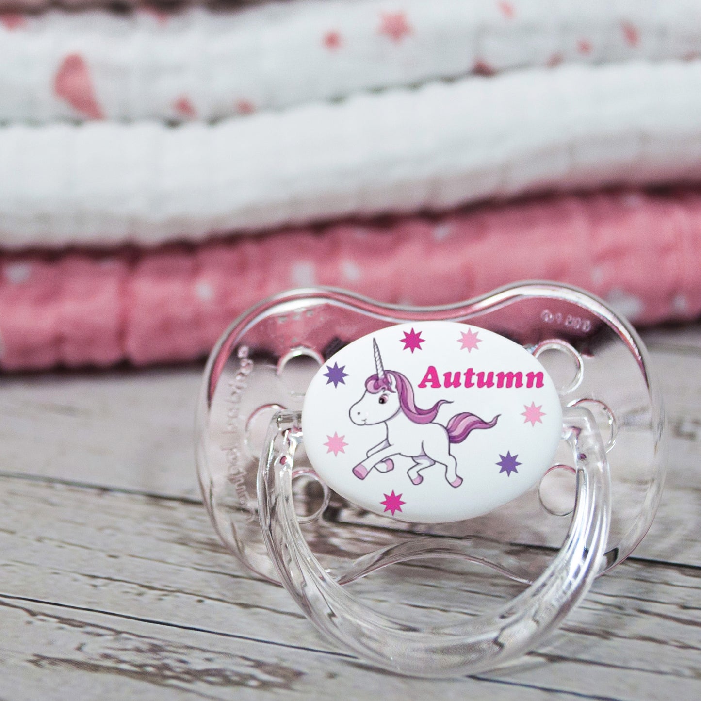 Personalised baby dummy with unicorn in pink and pink name.