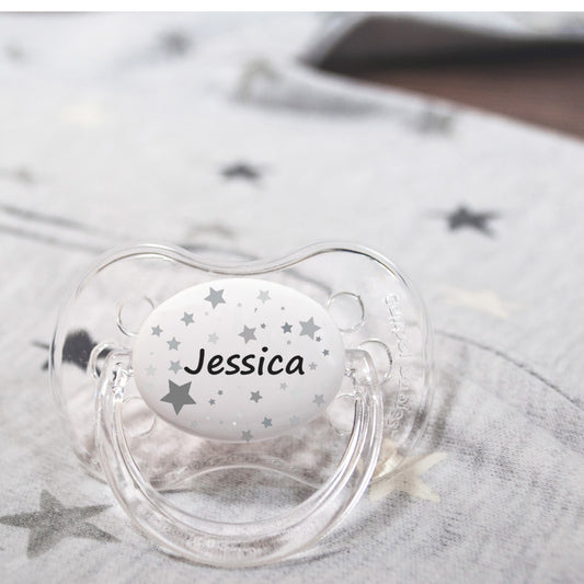 Personalised baby dummy with stars pattern and name.